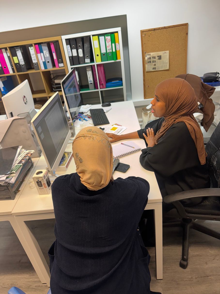 An adviser helping a resident at a computer during a one-to-one welfare advice session